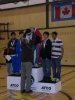 Dennis Bevington presents medals to the winners of the Arctic Winter Games Juvenile Male Badminton Doubles Competition. Here he presents gold ulus to Sequssuna Schmidt of Team Greenland. His team-mate Dennis Hansen was not present.