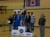 Dennis Bevington stands for the Greenland national anthem following his medal presentation to the winners of the Junior Male Badminton Doubles Competition. Sequssuna Schmidt and Dennis Hansen of Greenland took the gold medal. The silver went to Alexander Tuktudjuk and Louis Lebel of Team Nunavut, and the bronze went to Samuel-Jacob Andrews and Andy Jin-Tan of Team Northern Alberta.