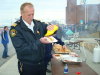 An RCMP officer puts mustard on his burger.