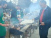 MP Bevington braves through the smoke to gather more burgers and hot dogs to feed the masses.
