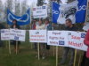 Members and employees of the North Slave Metis Alliance hoisted signs demanding a cease of Metis oppression at Somba K’e Park.