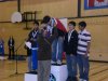 Dennis Bevington presents medals to the winners of the Arctic Winter Games Junior Male Badminton Doubles Competition. Here he presents gold ulus to Kaali Christensen and Sequssuna Schmidt of Team Greenland.