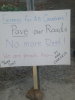 This sign at the Ndilo blockade states the reason why paved roads are needed – to decrease dust and help improve the air quality for residents.