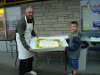 Dennis Bevington and Jonah Bevington carry the big cake to the celebration of Labour Day in Yellowknife